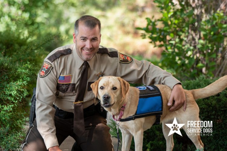 Police officer with service dog from Freedom Service Dogs