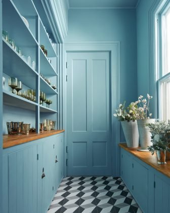 A Tranquil Blue color-drenched pantry by Benjamin Moore.