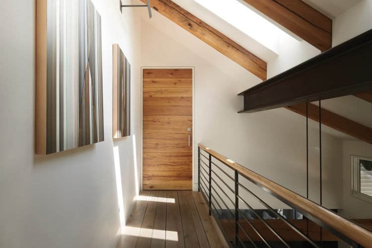 An interior pivot door at a home in Telluride made from horizontal plank reclaimed oak.