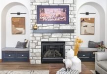 The ’80s Design Trends of 2025 Arched nooks create cozy spots next to the fireplace in this great room designed by Denver Design Group.