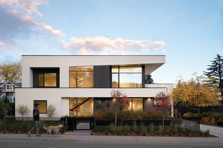 This contemporary home utilizes an existing home’s foundation and footprint with an entirely different aesthetic. Large window and door openings bring in substantial natural light.