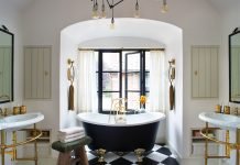 Tudor Meets Bohemian in a Sophisticated Denver Bathroom Bathtub sits in front of window in the bathroom designed by Chalet.