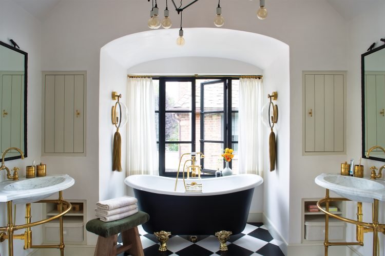 Bathtub sits in front of window in the bathroom designed by Chalet.