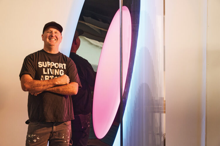 Collin Parson poses with his artwork.