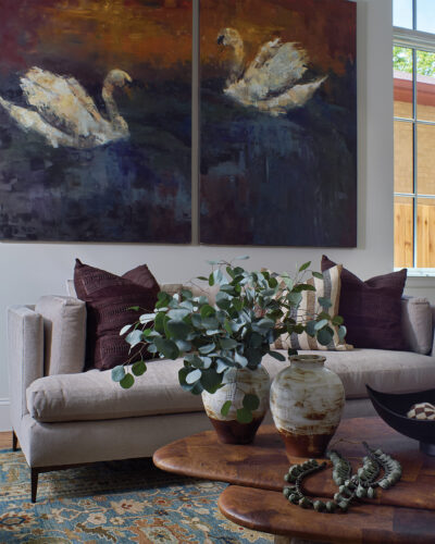 Close up of couch and artwork behind in the 2026 Home & Garden Colorado Designer Showhouse.