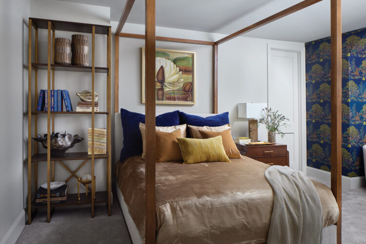 Large canopy bed and bookshelves in the lower-level bedroom in the 2026 Home & Garden Colorado Designer Showhouse.
