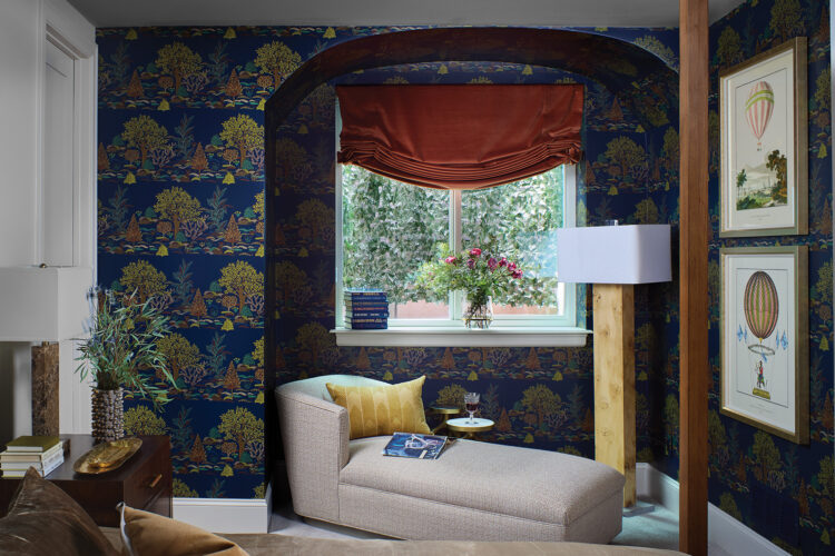 Lounge chair sits in an arched window in the lower-level bedroom in the 2026 Home & Garden Colorado Designer Showhouse.