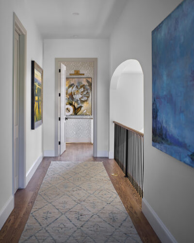 The upstairs hallway overlooking the living area in the 2026 Home & Garden Colorado Designer Showhouse.