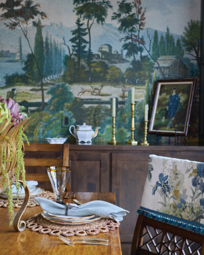 “Pastoral Scene 1 and 2,” a mural by John Derian for Design Guild, sets the tone for the dining room. The barrel-shaped ceiling is painted with Sherwin Williams’ Rainwashed.